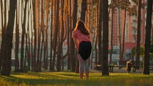 Woman warming up for exercise in a park