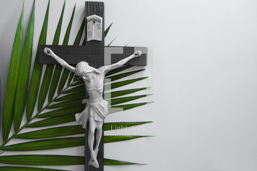 crucifix with green palm frond on a white background 