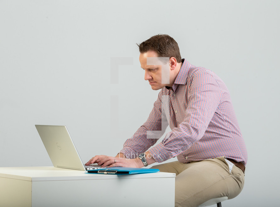 a man on a laptop computer 