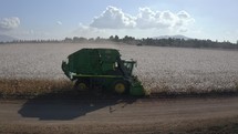 Aerial footage of cotton harvester in a large scale cotton field during harvest