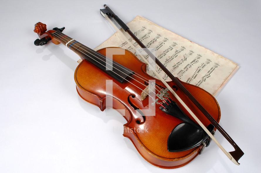 violin, bow, and sheet music 