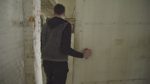 a man walking through a warehouse door 