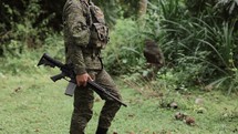 Military Soldier Walks Through The Jungle Carying A Gun Weapon Warfare