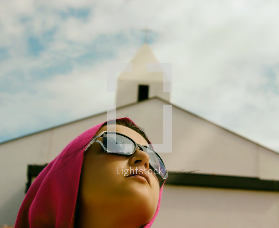 Woman With Pink Headcloth and Church in Background