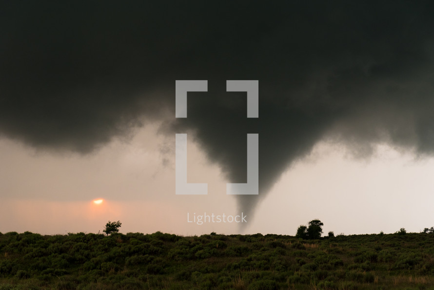 A Tornado With The Setting Sun In The Background