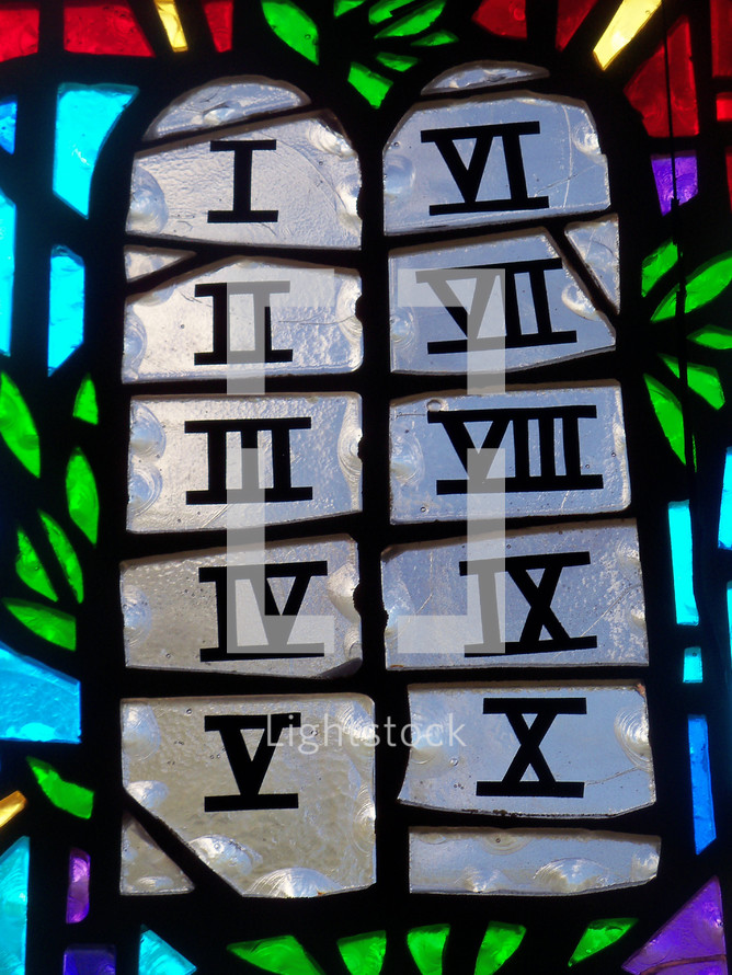 A stained glass window depicting the stone tables that make up the ten commandments given by God to Moses on Mount Sinai when the Israelites were wandering the desert in search of the promised land. 