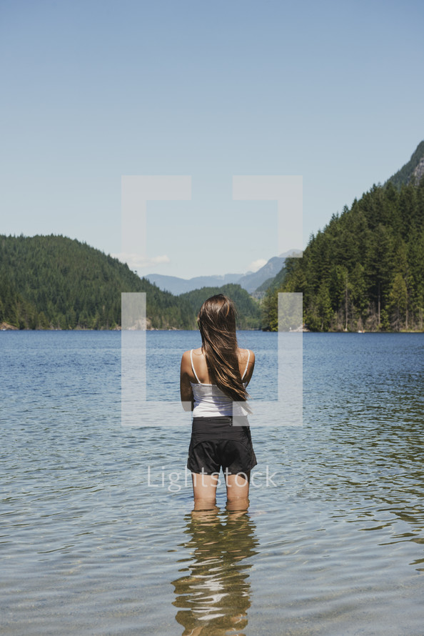 young woman standing in a lake 