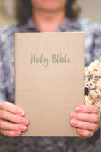 woman holding a Holy Bible 