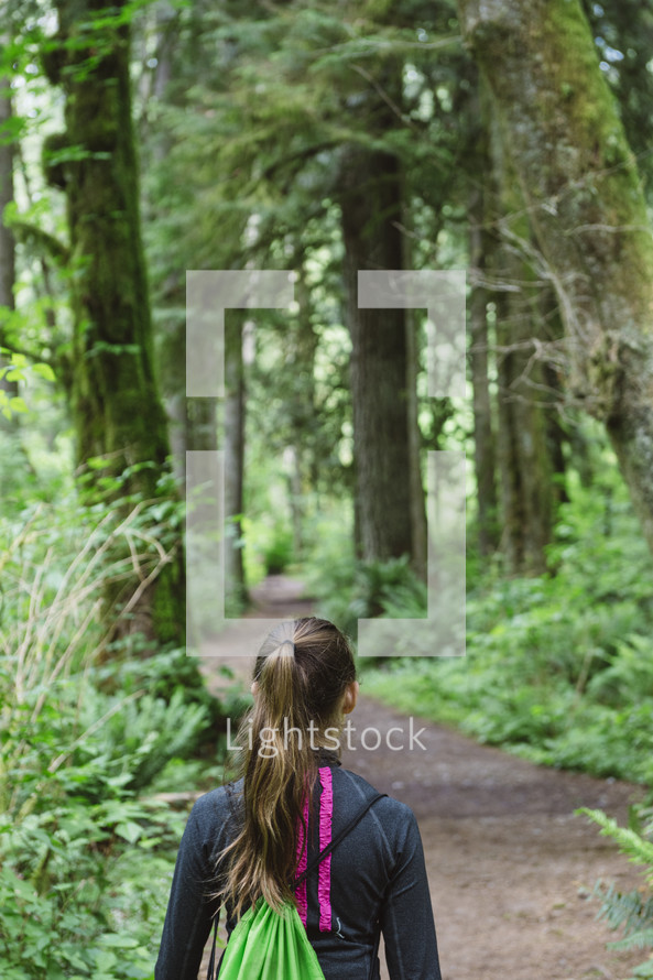 teenage girl hiking in the woods 