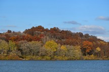 Fall trees on hill next to water