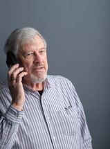 man with a beard talking on a phone 