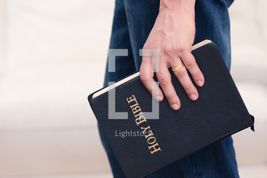 a man carrying a Bible at his side 