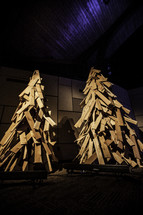 Two Christmas trees constructed of wooden boards.