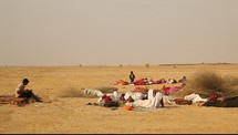 nomads sleeping on the desert sand 