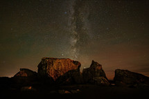 milky way galaxy behind rocks at Moonstone beach 