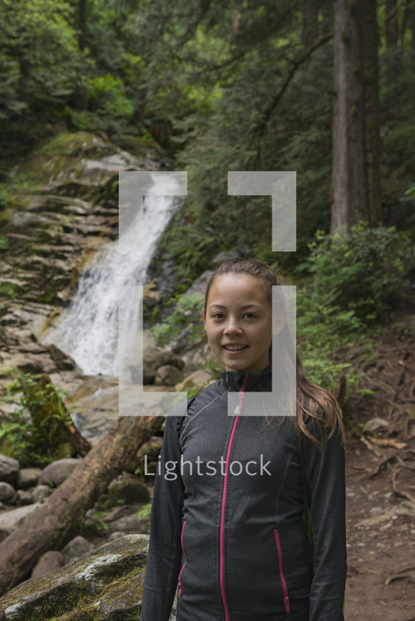a Teenaged Girl Hiking Near Waterfall