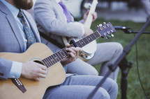 men playing guitars at a wedding 