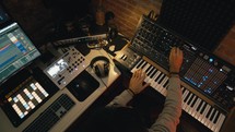 Dj producer is mixing a new music track in the sound studio design