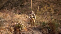 A man backpacking and hiking in the desert wilderness