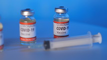 covid-19 vaccine vials and syringe 