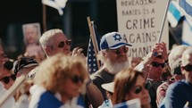 A crowd of supporters at a support Israel rally clapping