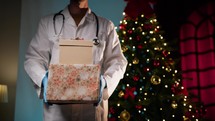 Doctor offering Christmas gifts for holidays celebration