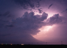 Lightning Illuminates Dark Storm Clouds In The Night Sky