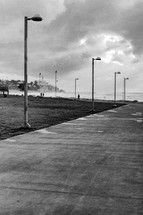 Lampposts and clouds  by the beach in Tel Aviv - black and white