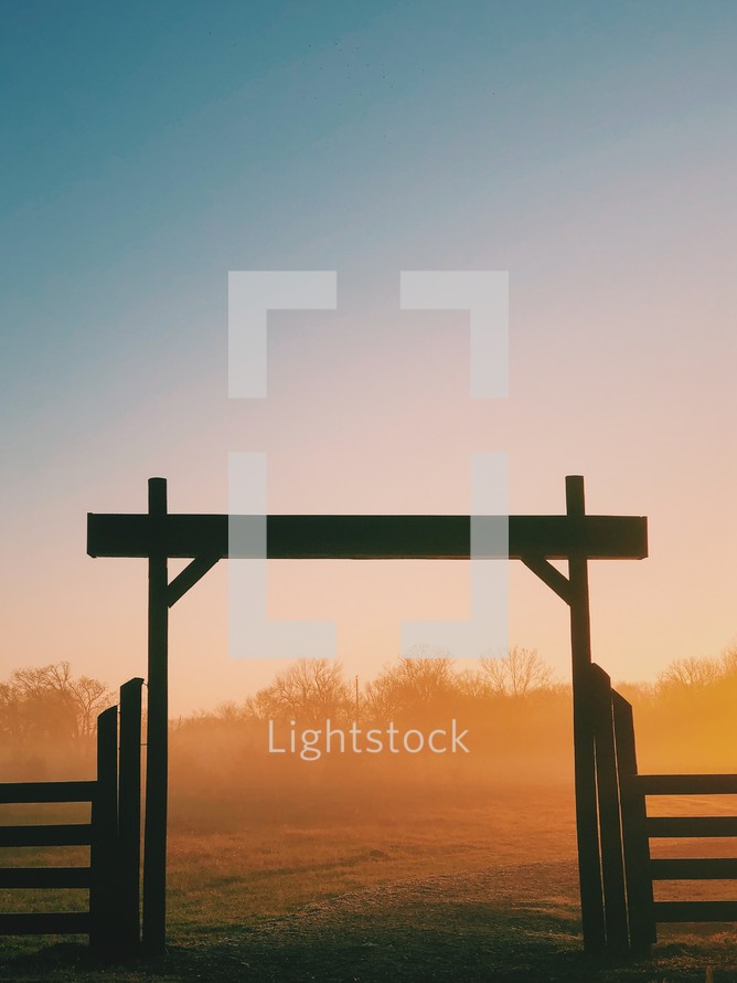 gate and fence on a ranch at sunrise 