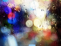 Bokeh image of raindrops on a window pane.