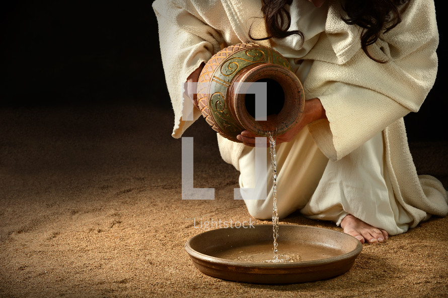 Kneeling Jesus pouring water from an urn into a bowl.