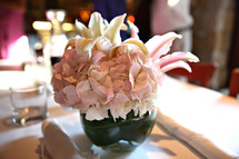 flowers in a vase as a centerpiece on a table