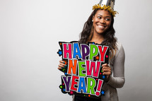 A woman holding a Happy New Year sign.