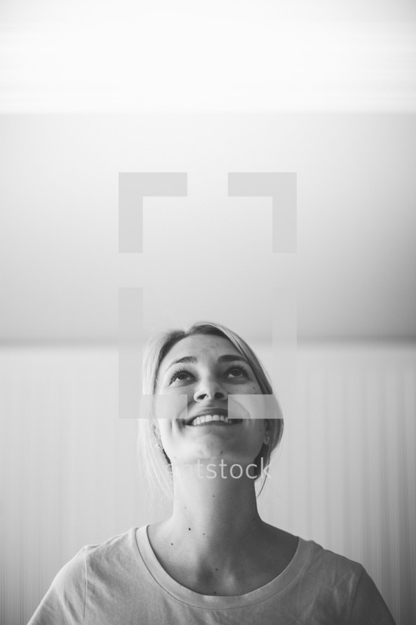 smiling woman looking up to god