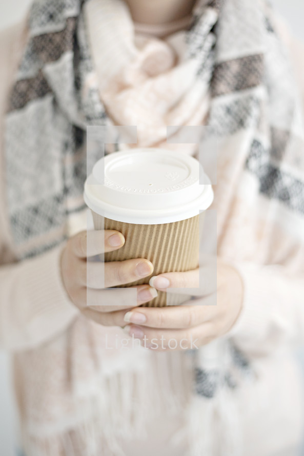 a woman holding a coffee cup 