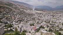 Aerial pullback over Gjirokastër Fortress, view of UNESCO World Heritage city