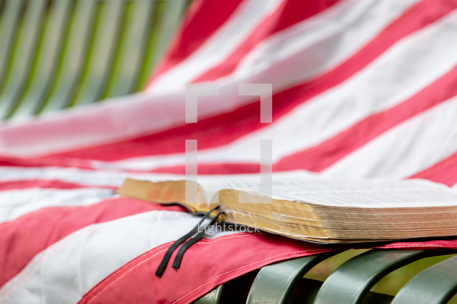 American flag and Bible on bench