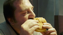Man eating a hamburger.