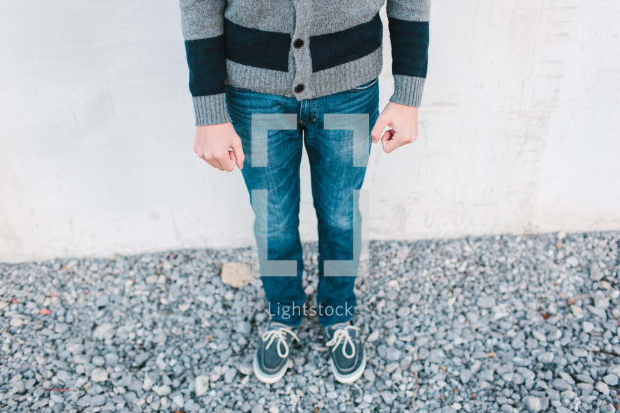 legs of a boy wearing a sweater 