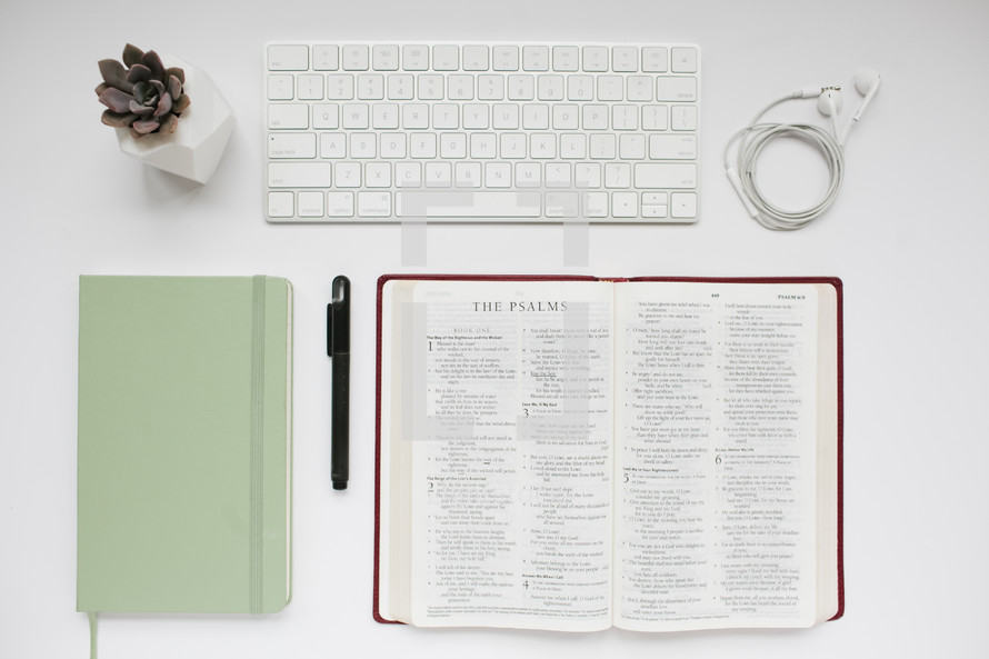 succulent plant, journal, mint green, pen, open Bible, pages, white background, earbuds, computer keyboard, desk, Bible study, modern
