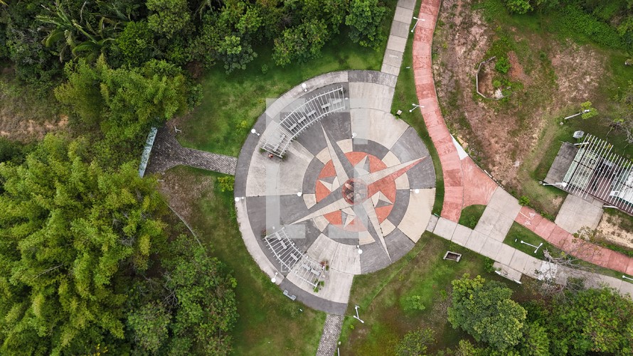 Aerial photo taken with drone of 8-point star in middle of park on cloudy afternoon