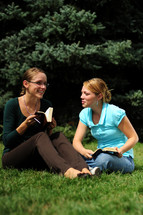 teen girsl reading a Bible outdoors 