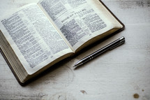 open Bible and pen