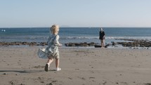 Little girl running to dear mom at the seaside