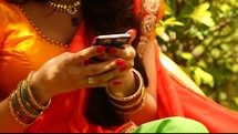 a woman in India texting on a cellphone