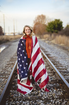 a woman wrapped in an American flag 