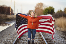 woman running holding an American flag 