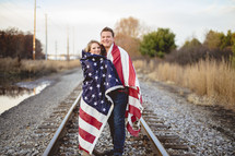 couple wrapped in an American flag 