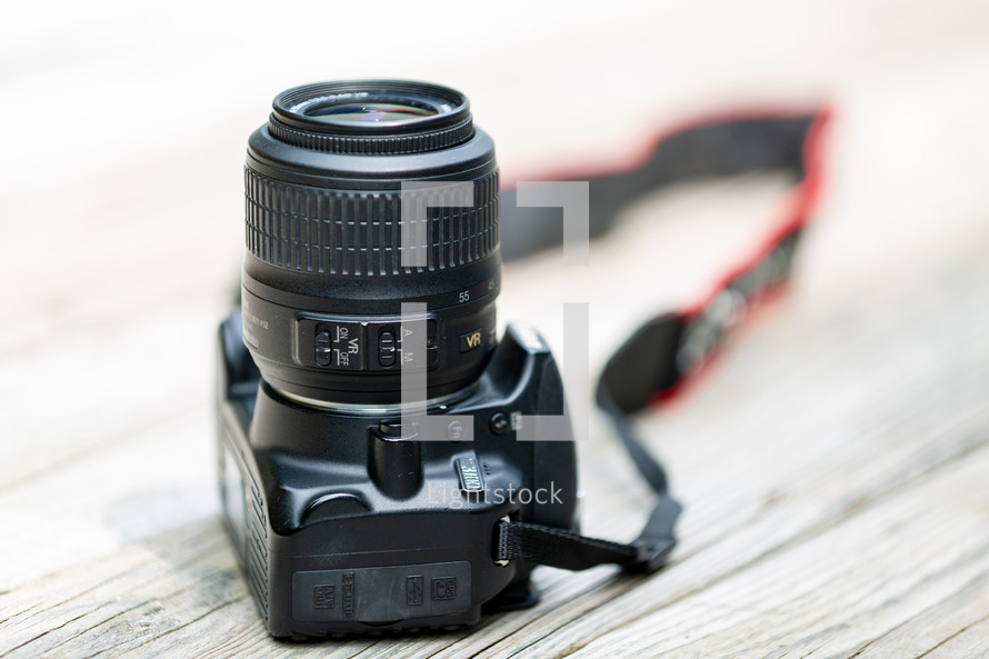 dslr camera and lens on wooden surface