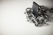 Chain wrapped around a cell phone.